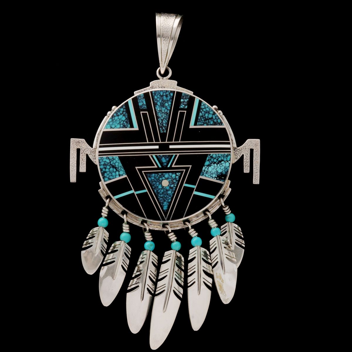 AN INLAID STERLING KACHINA MASK PENDANT SIGNED TRACEY