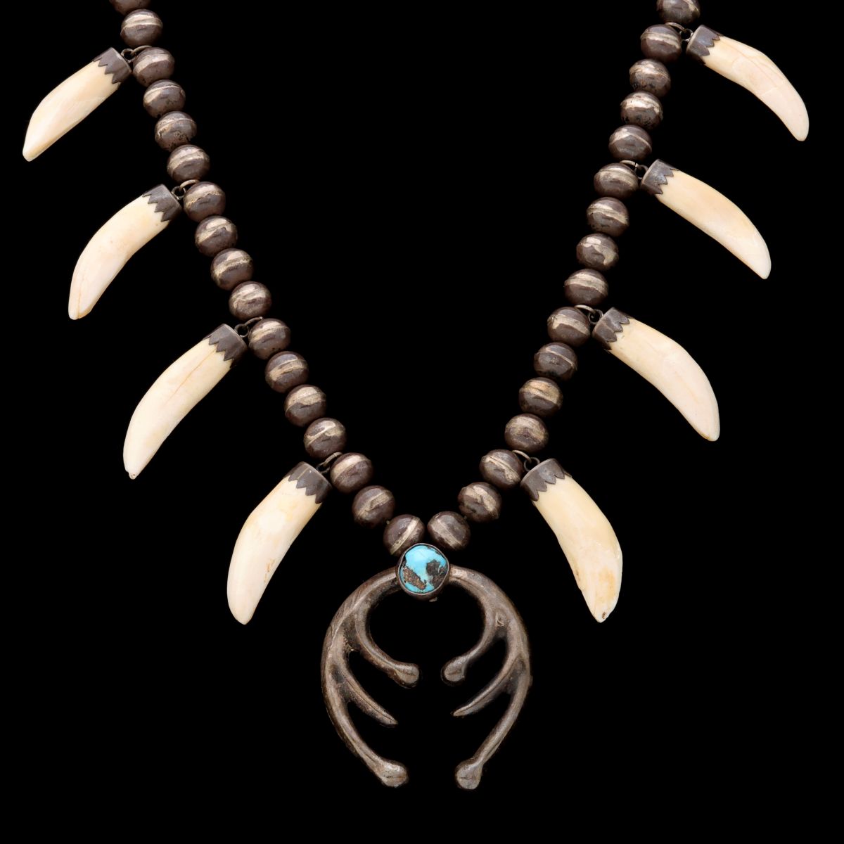 A NATIVE AMERICAN ANIMAL TOOTH & STERLING NAJA NECKLACE