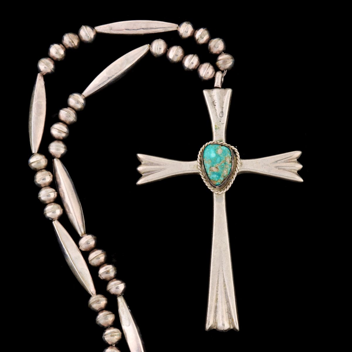 A NAVAJO STERLING SILVER AND TURQUOISE CROSS NECKLACE