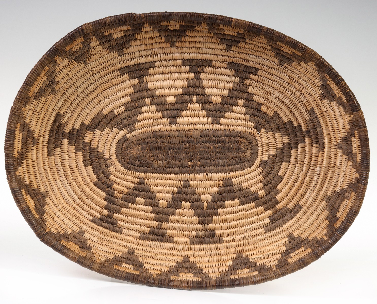 AN EARLY 20TH CENTURY APACHE SHALLOW OVAL BOWL