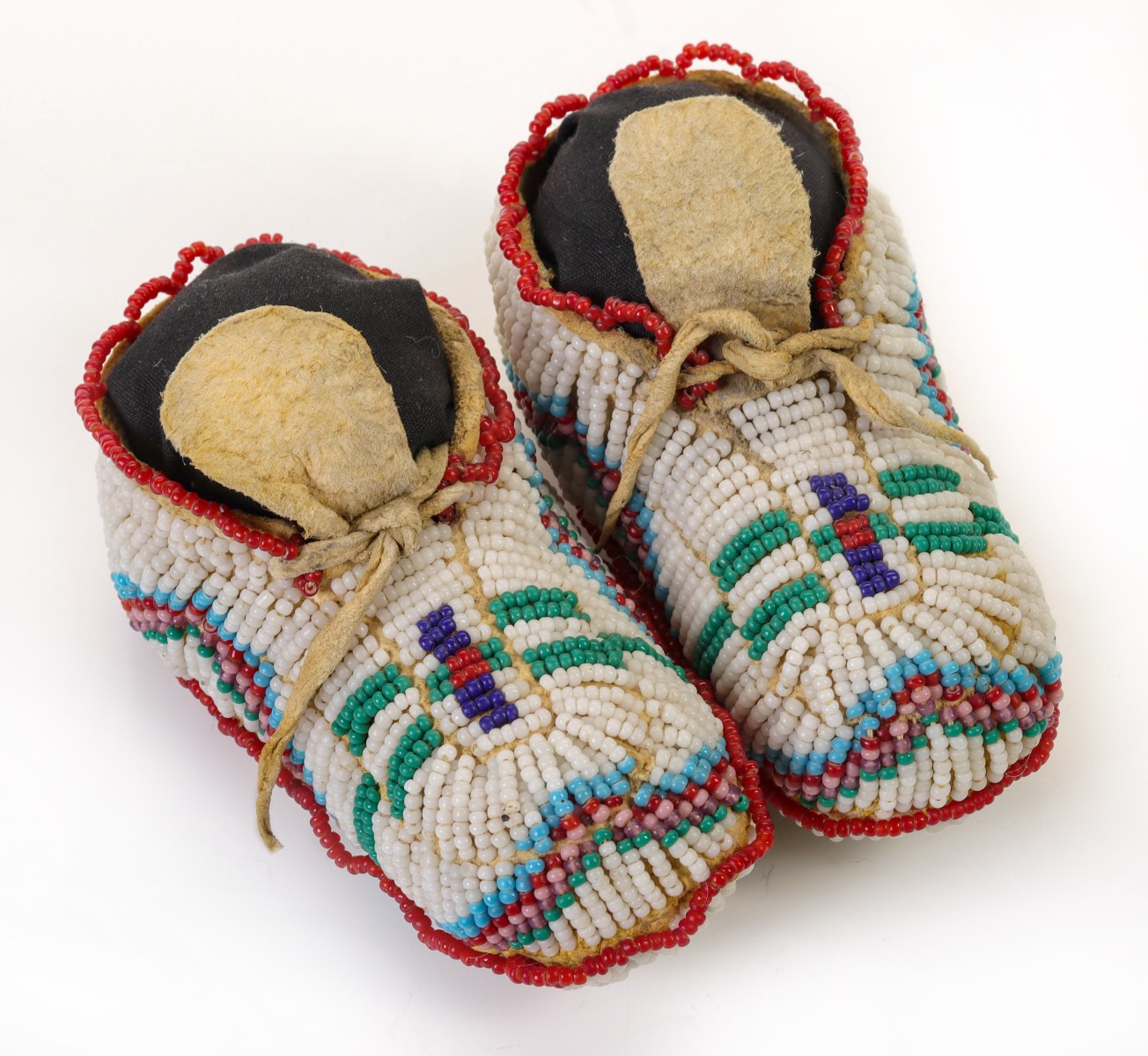 PLAINS CHILD MOCCASIN PAIR WITH BEADED SOLES C. 1920