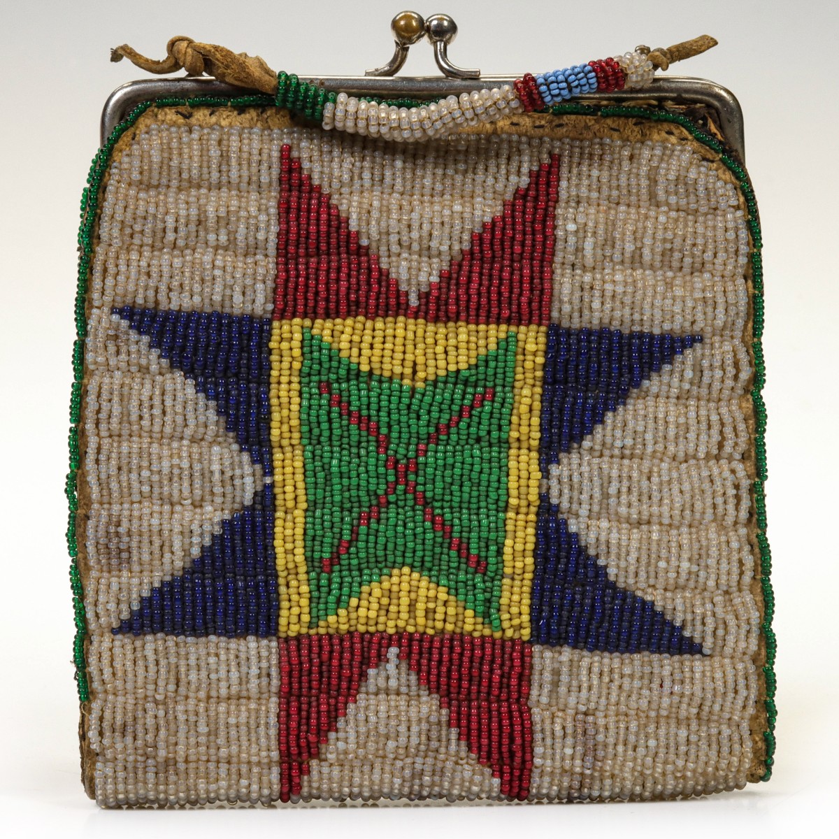 A COMMERCIALLY MADE PURSE WITH PLAINS REGION BEADING