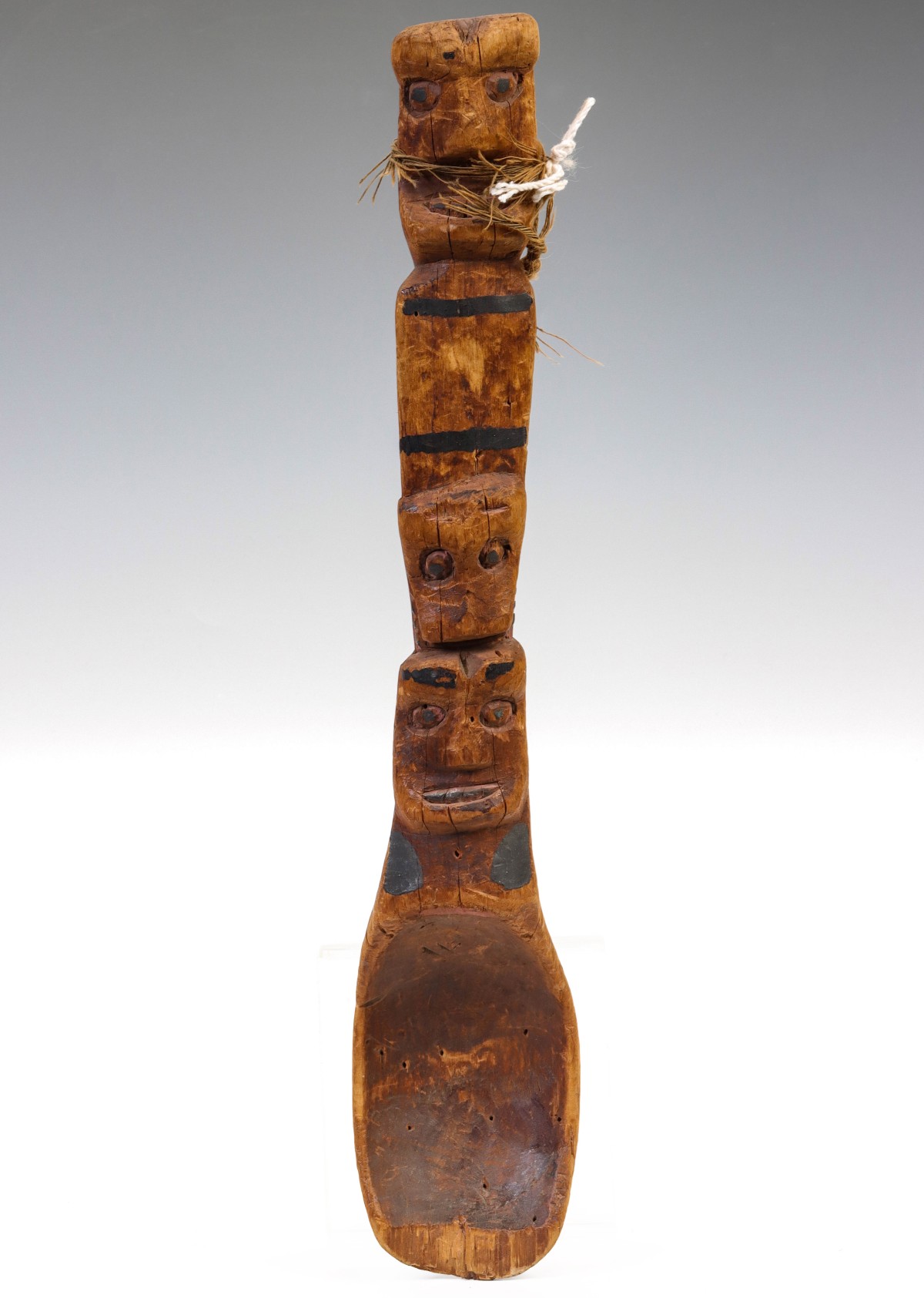 A CARVED SPOON OF UNKNOWN ORIGIN WITH TOTEMIC FIGURES