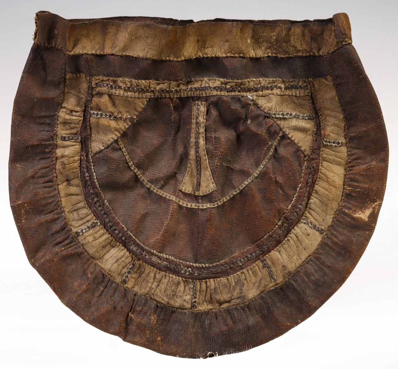 AN INTERESTING ATHABASCAN POUCH OF VARIOUS HIDE MATERIAL