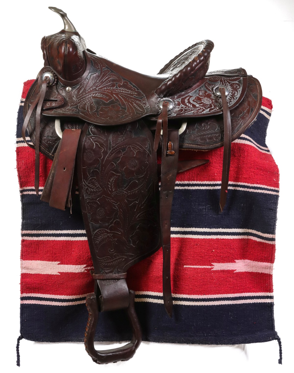 AN ELABORATE TOOLED LEATHER SADDLE STAMPED MOSS CHANUTE