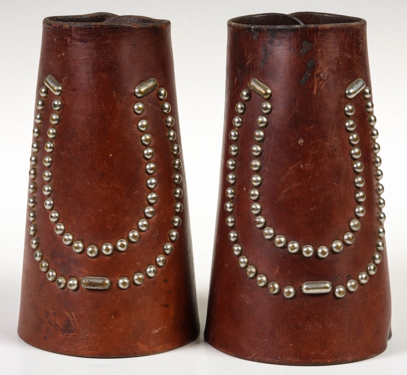 A PAIR OF ASKEW LEATHER CUFFS WITH HORSESHOE MOTIF