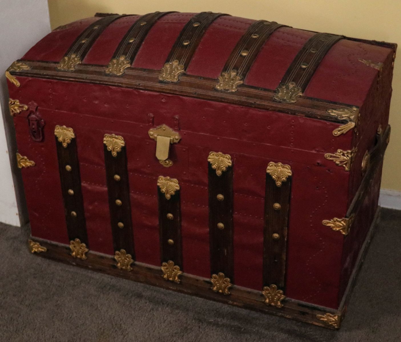 A 19TH CENTURY 'HUMP BACK' TRAVEL TRUNK WITH WOOD
