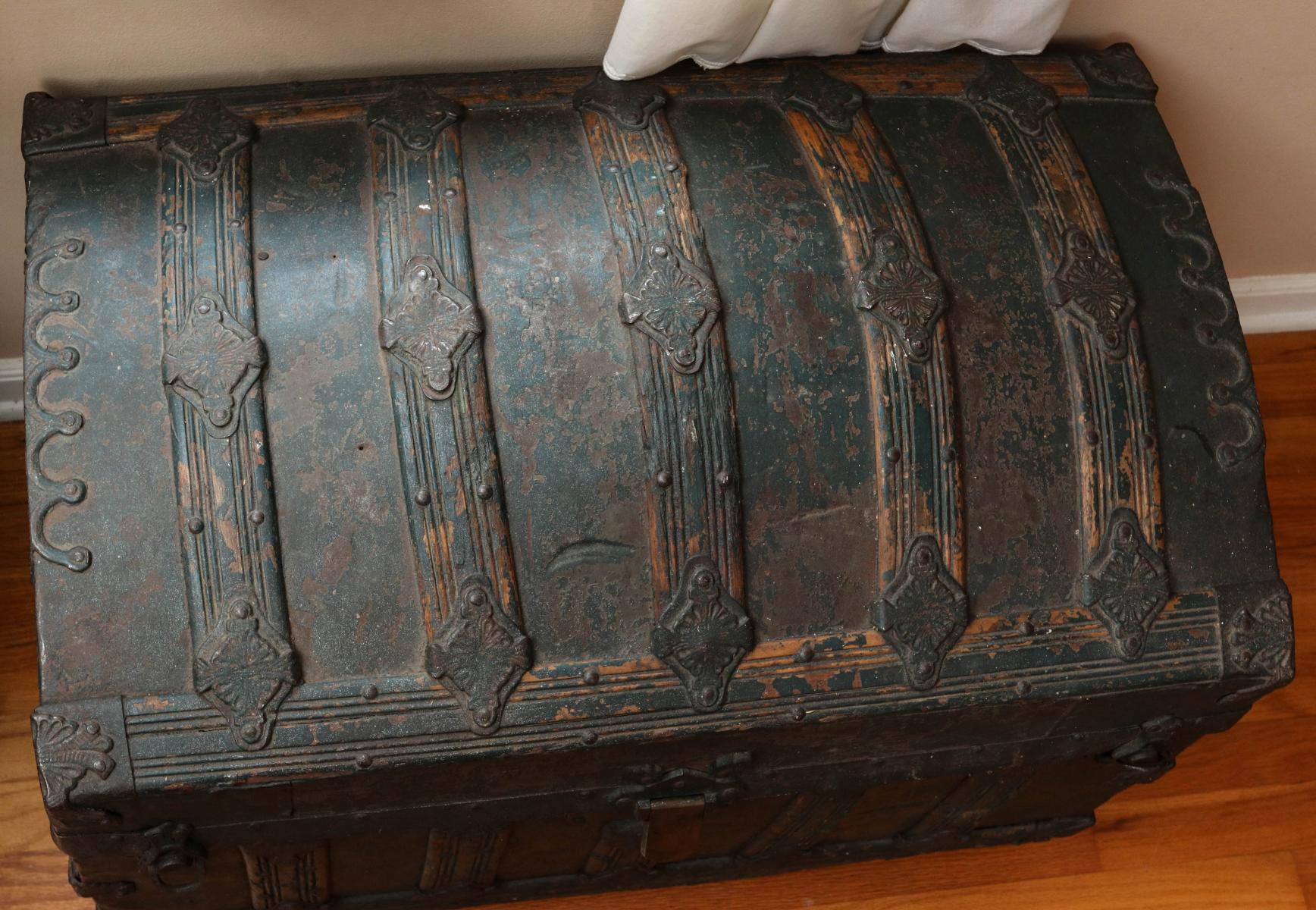 A VICTORIAN HUMP BACK TRUNK IN OLD GREEN PAINT