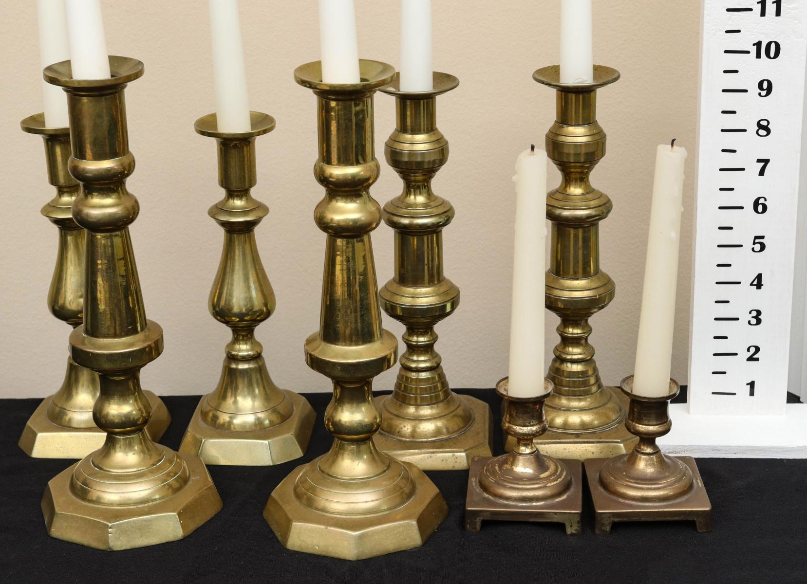 ANTIQUE BRASS PUSH-UP AND OTHER CANDLESTICKS