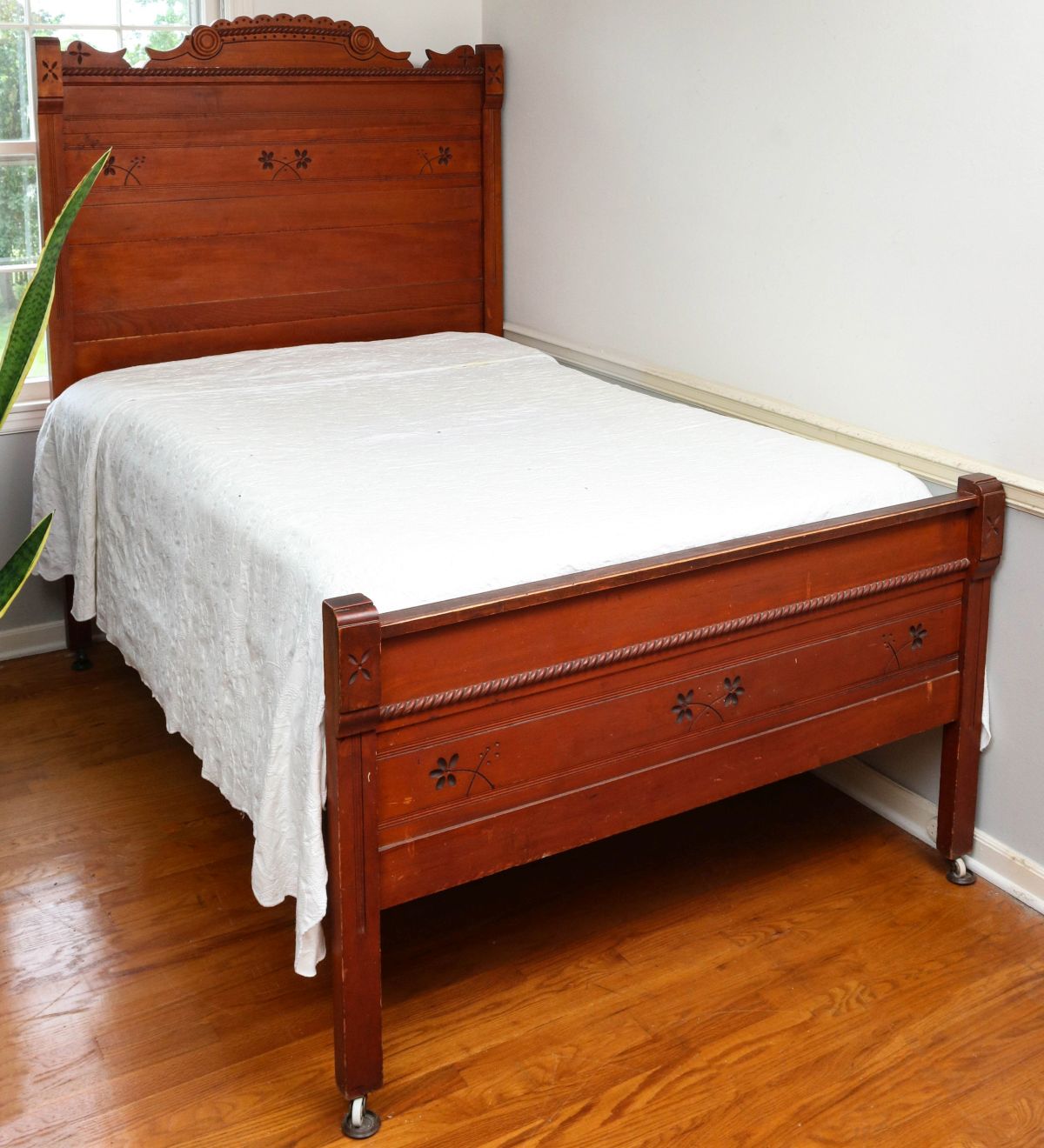 A 3/4 SIZE EASTLAKE STYLE BED HEAD AND FOOT BOARD
