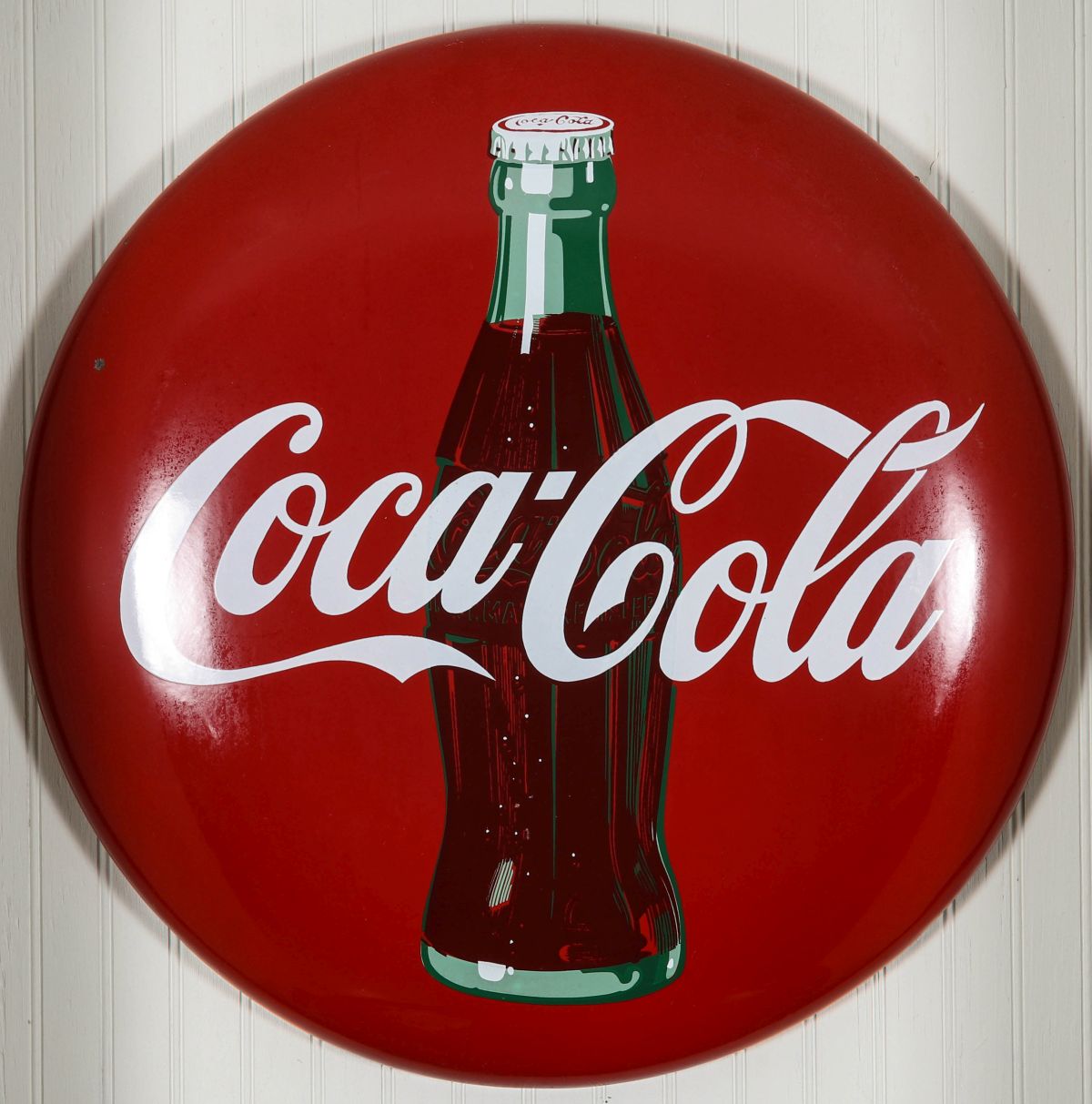 A 24-INCH COCA-COLA BUTTON SIGN WITH BOTTLE