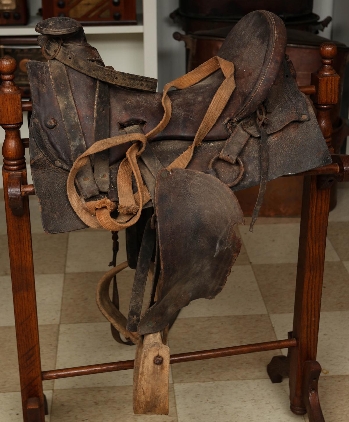 AN EARLY 20TH CENTURY HIGH BACK WORK SADDLE
