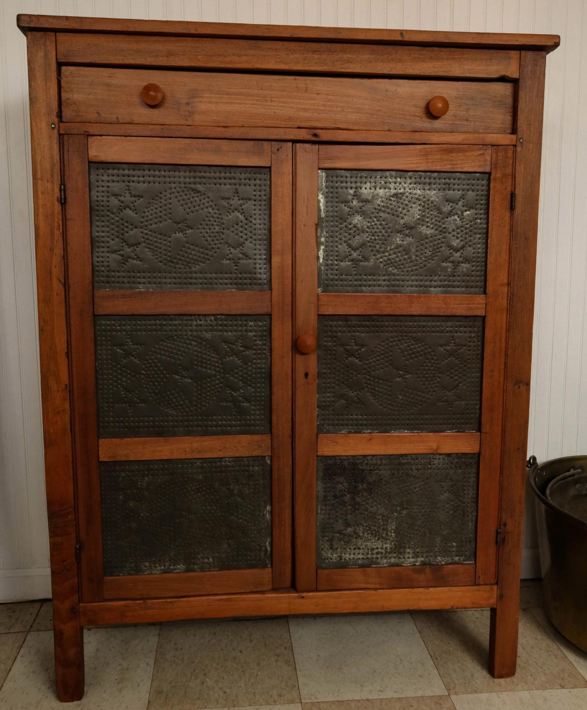 AN EARLY 20TH C. PIE SAFE WITH SIX STAR PUNCH TINS