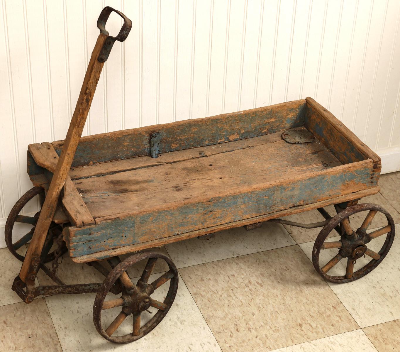 A 1900s IRON WHEELED COASTER WAGON IN OLD PAINT