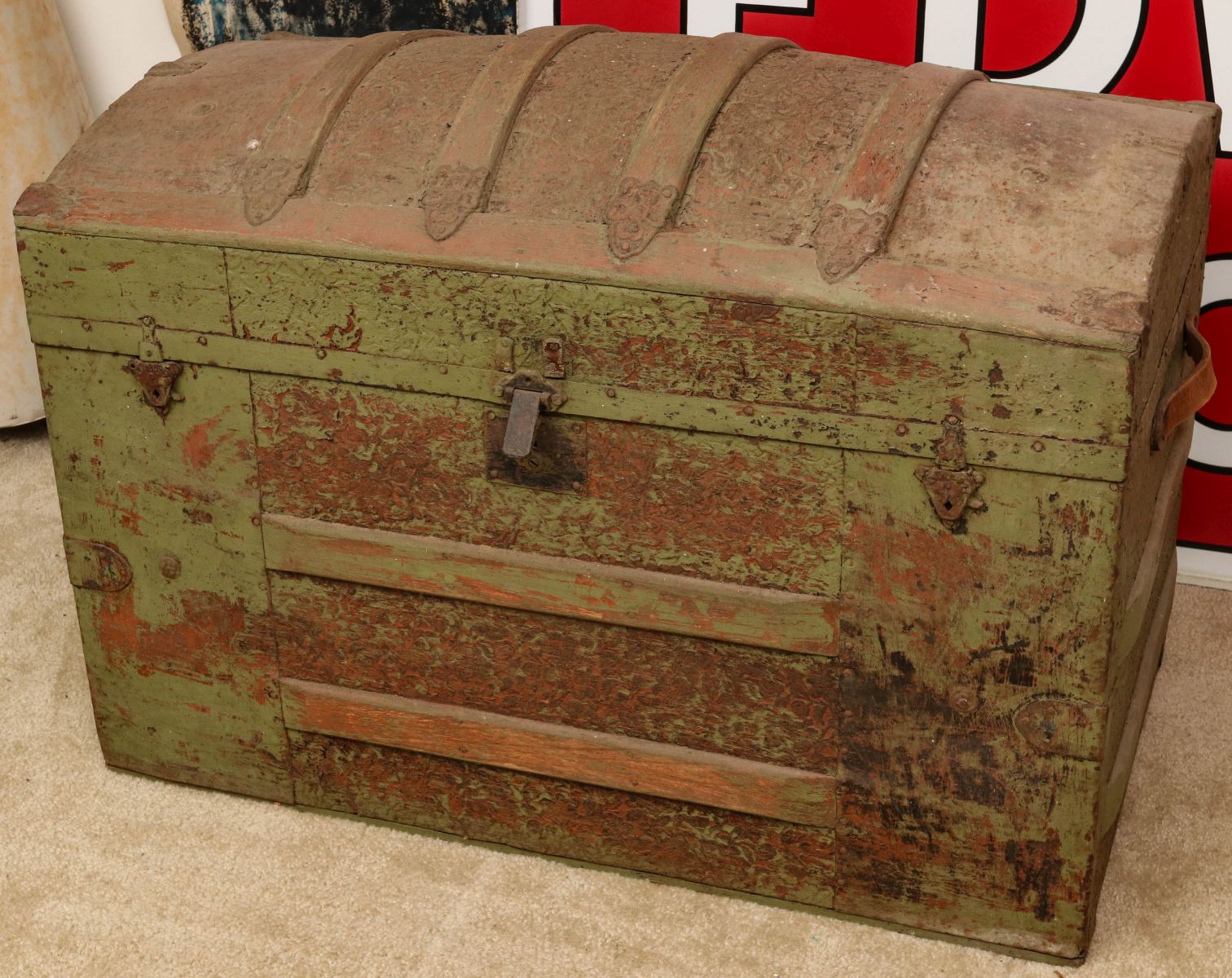 A VICTORIAN HUMP BACK TRUNK IN OLD GREEN PAINT