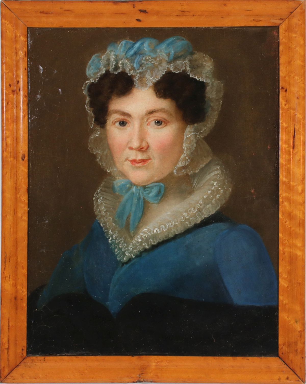 AN EARLY 19TH C. PORTRAIT OF WOMAN IN BLUE MOBCAP