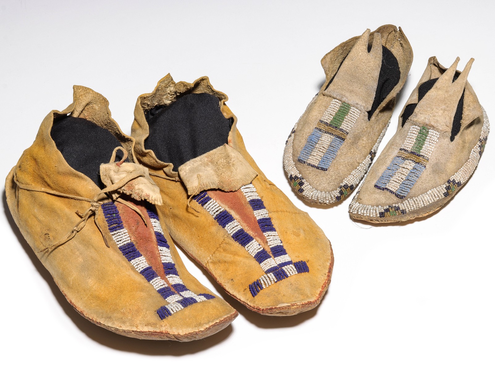 TWO PAIR OF PLAINS BEADED HIDE MOCCASINS
