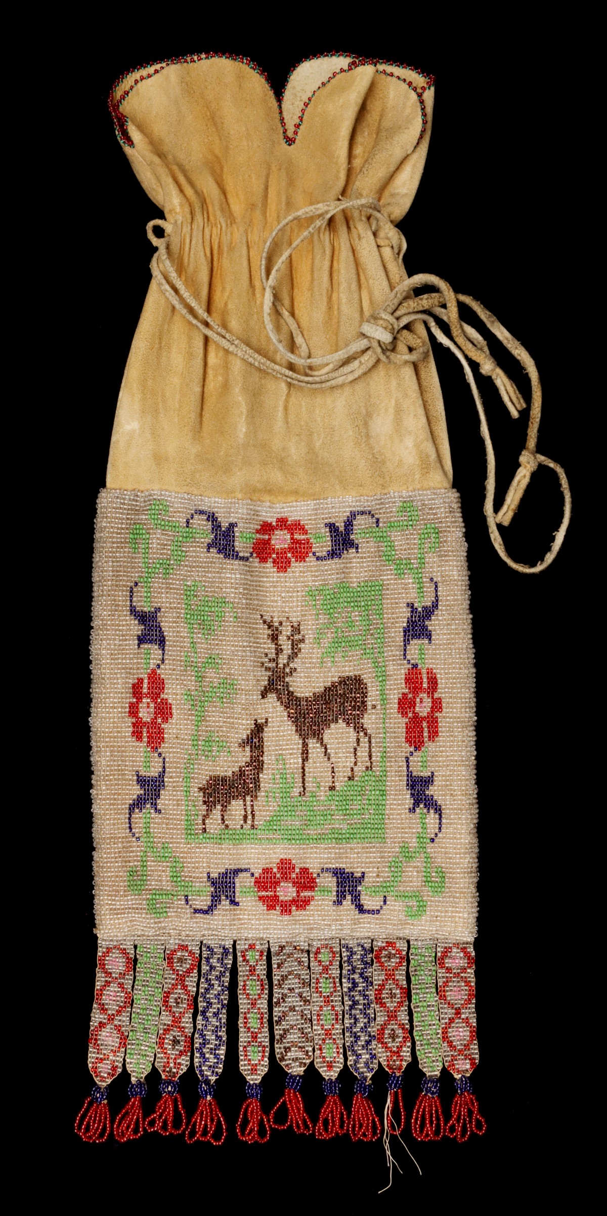 A GREAT LAKES BEADED HIDE PIPE BAG WITH ELK