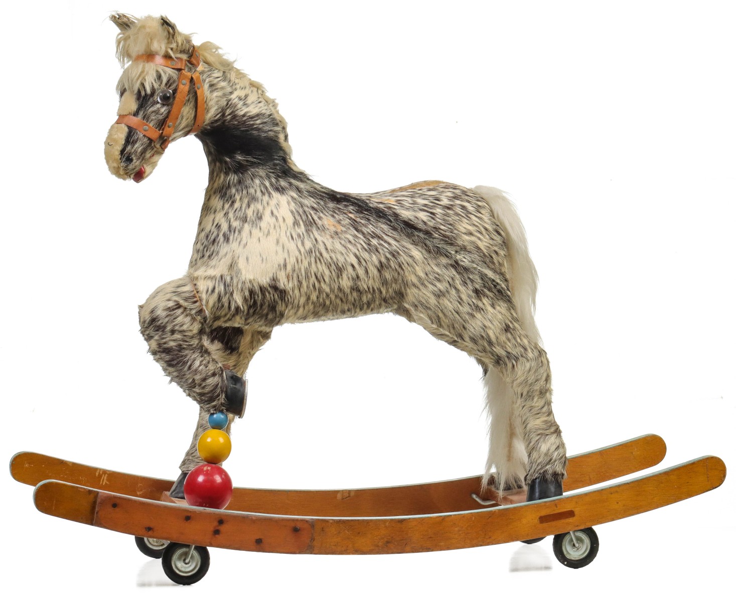 A LONG-HAIRED HIDE COVERED PONY ROCKING HORSE