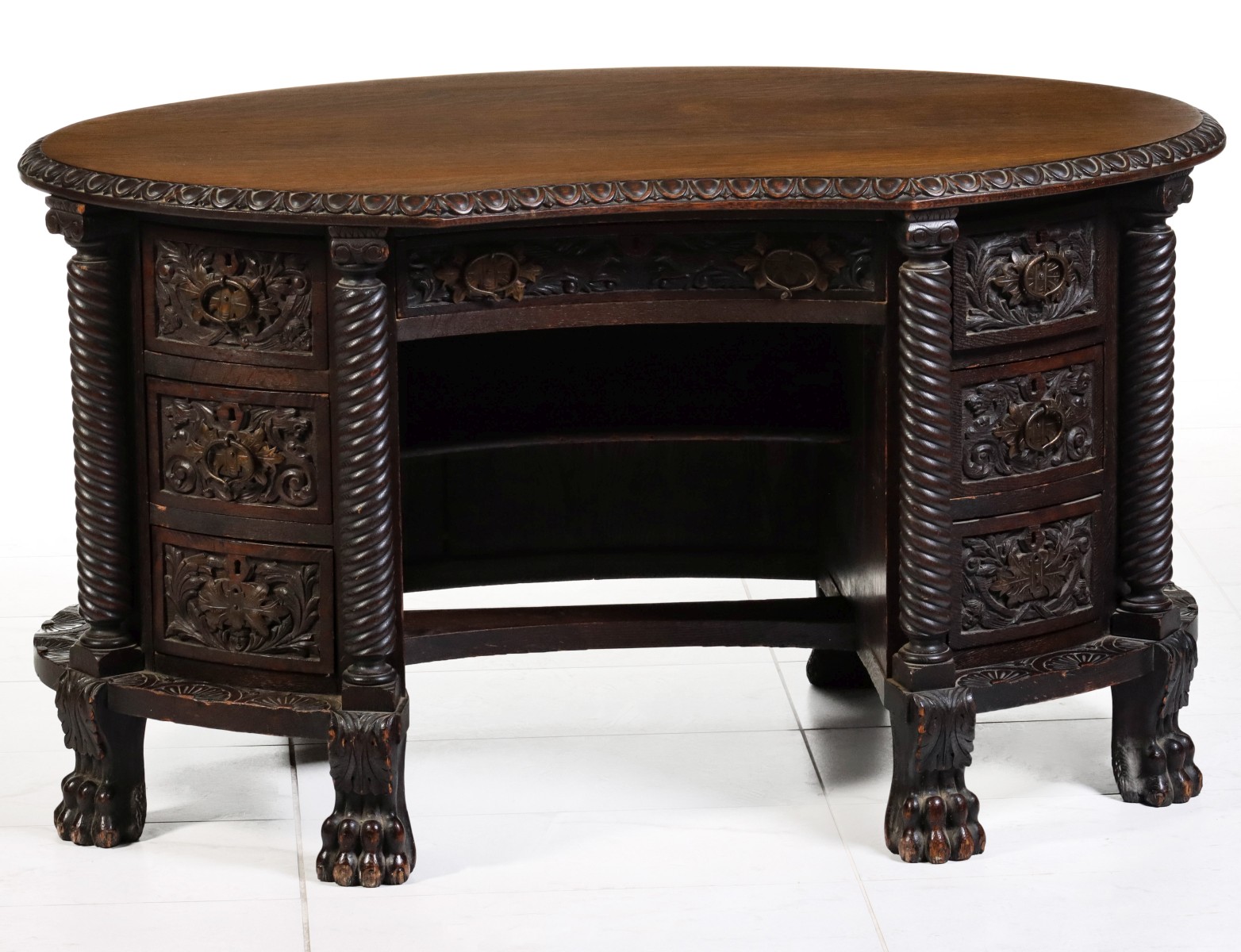 AN UNUSUAL AND HEAVILY CARVED OAK DESK CIRCA 1890